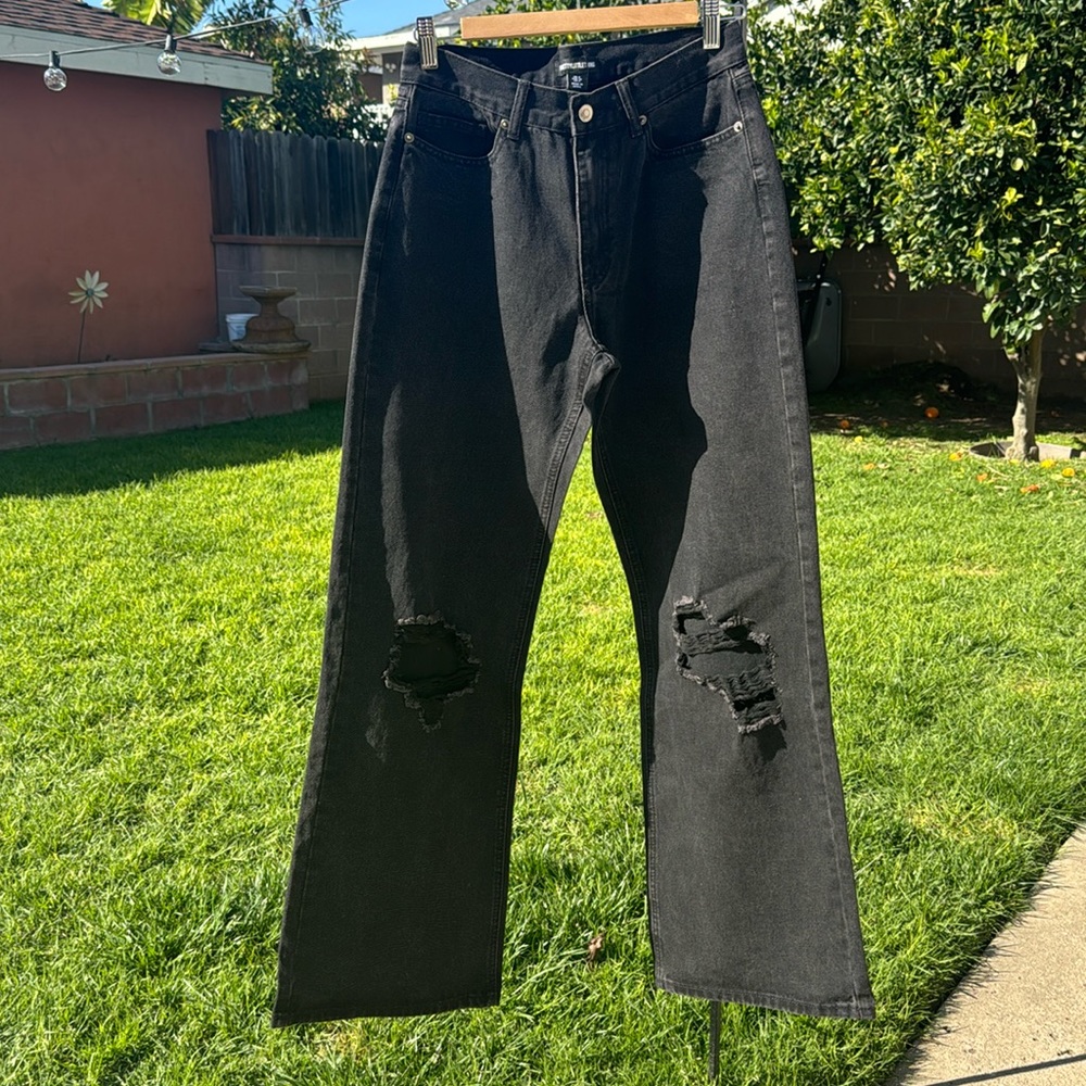 Women’s black washed ripped jeans, wide on the leg. Size 4, or loose fit